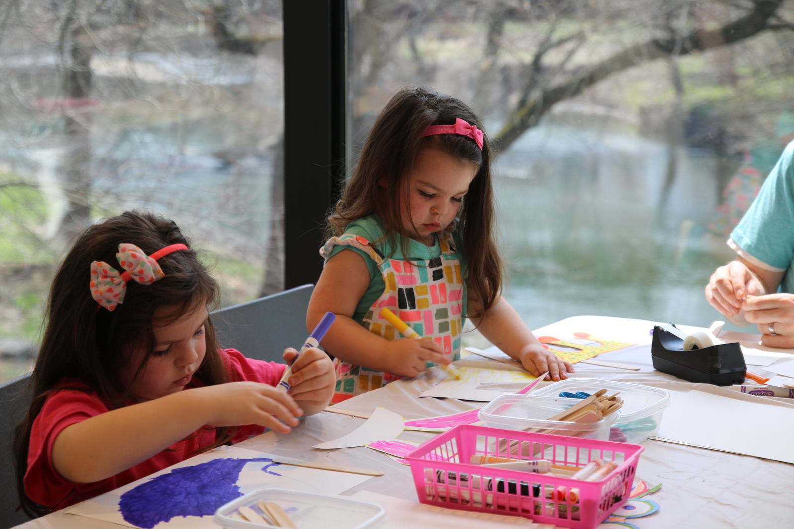 Two young children making arts and crafts