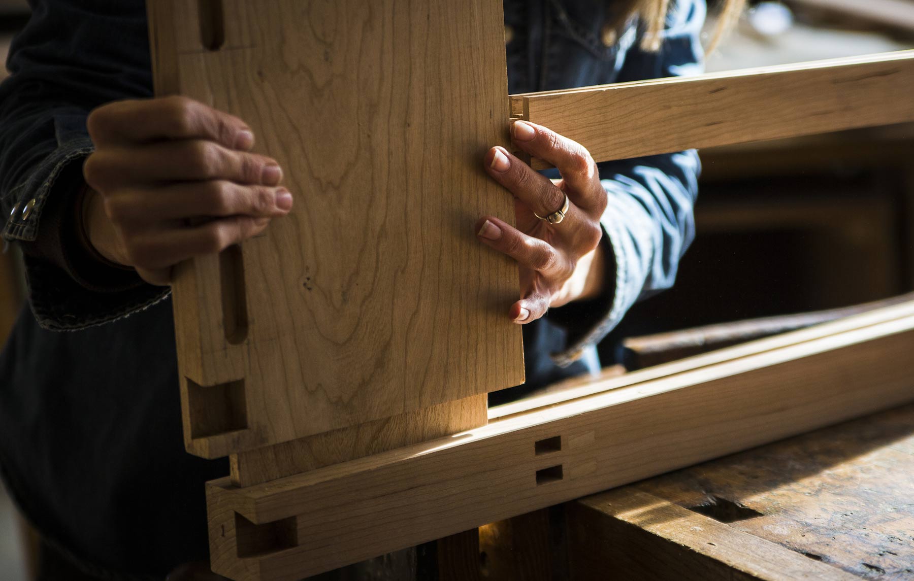 Close shot of hands joining wood together.