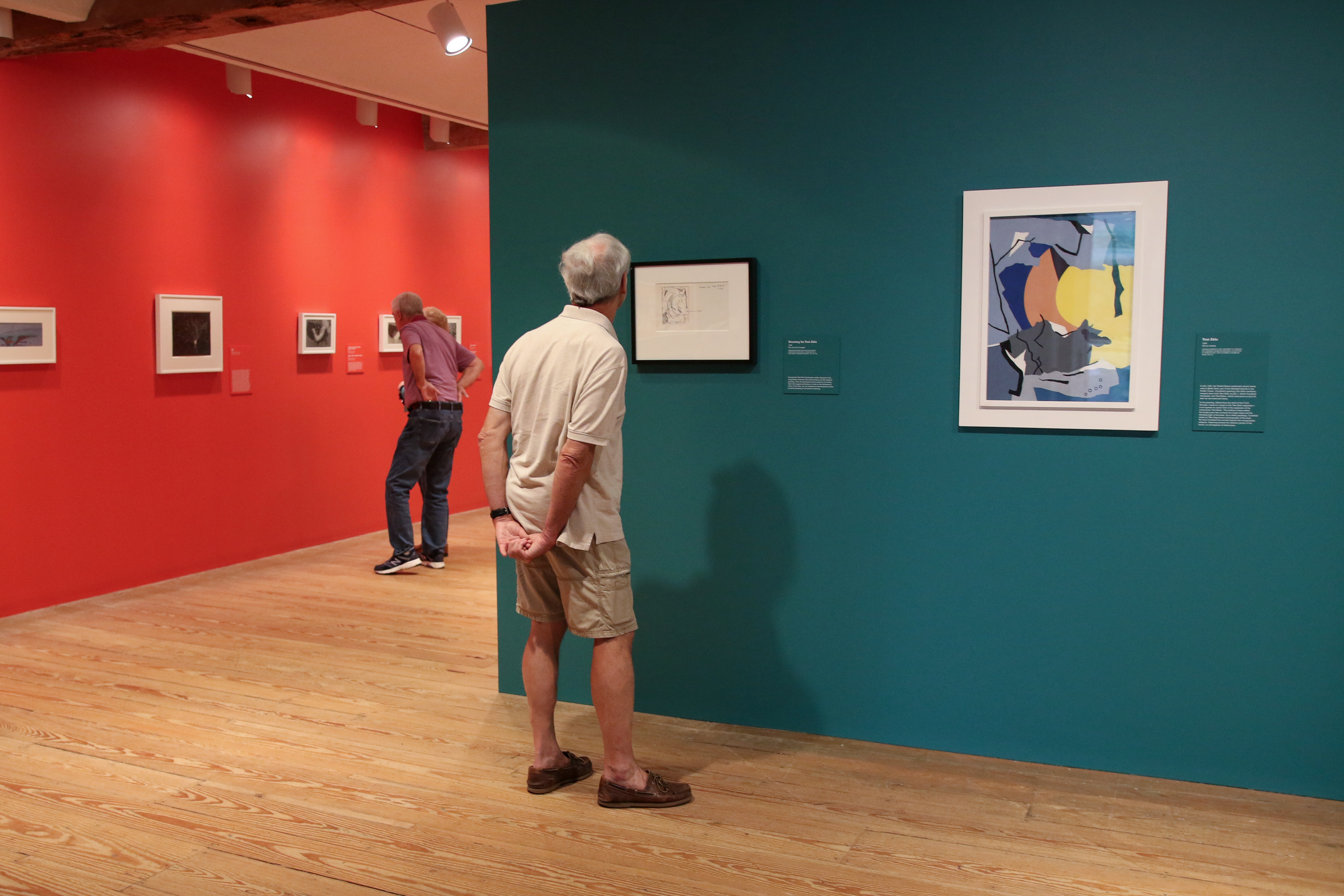 Man looking at a painting in an art gallery