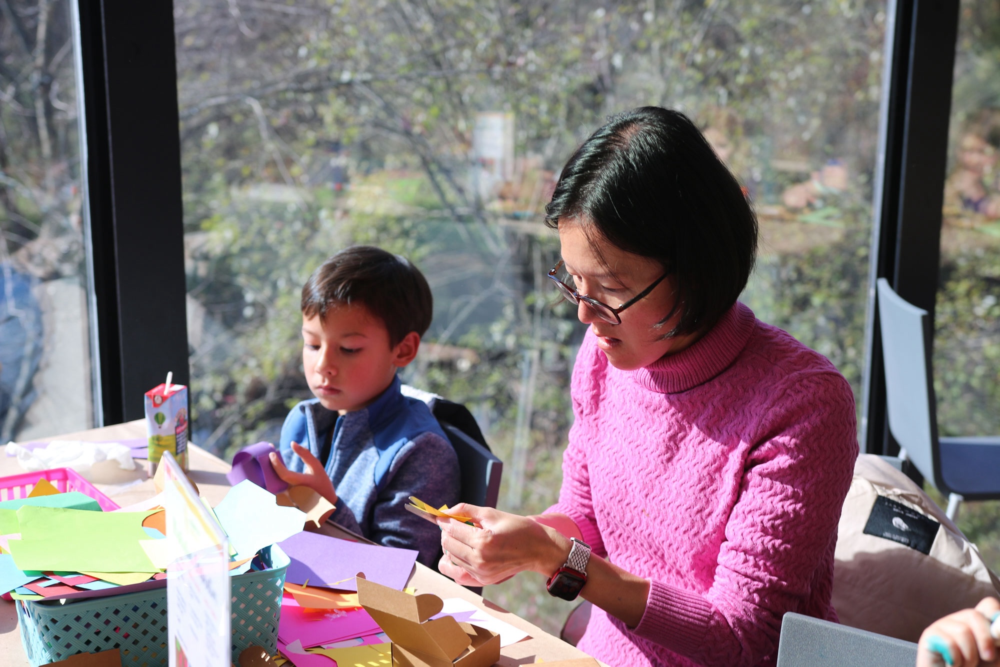 Woman making art with a child