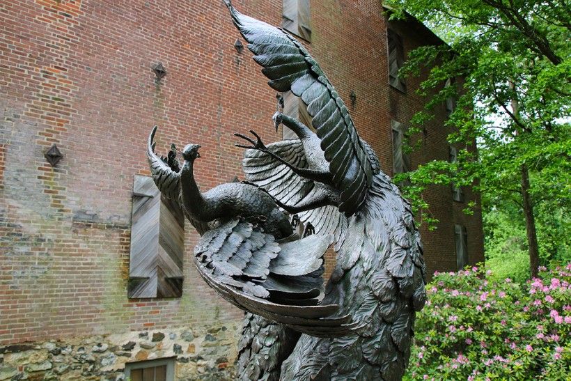 Close up of "Tipping Point" bronze sculpture of dueling peacocks