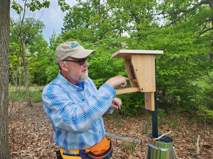 D. Scott Jones checks a bluebird box at Penguin Court. 