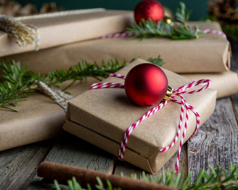 photo of brown paper wrapped Christmas presents tied with string.