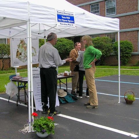 People under a tent talking at an event