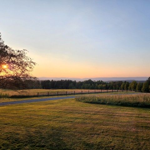 Sunset over wide open field at Penguin Court Preserve