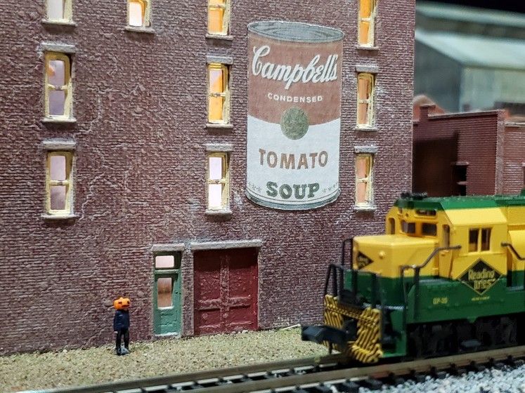 View of Jamie Wyeth's N-Gauge train display, featuring a miniature figurine depicting Wyeth's "Pumpkinhead" self-portrait